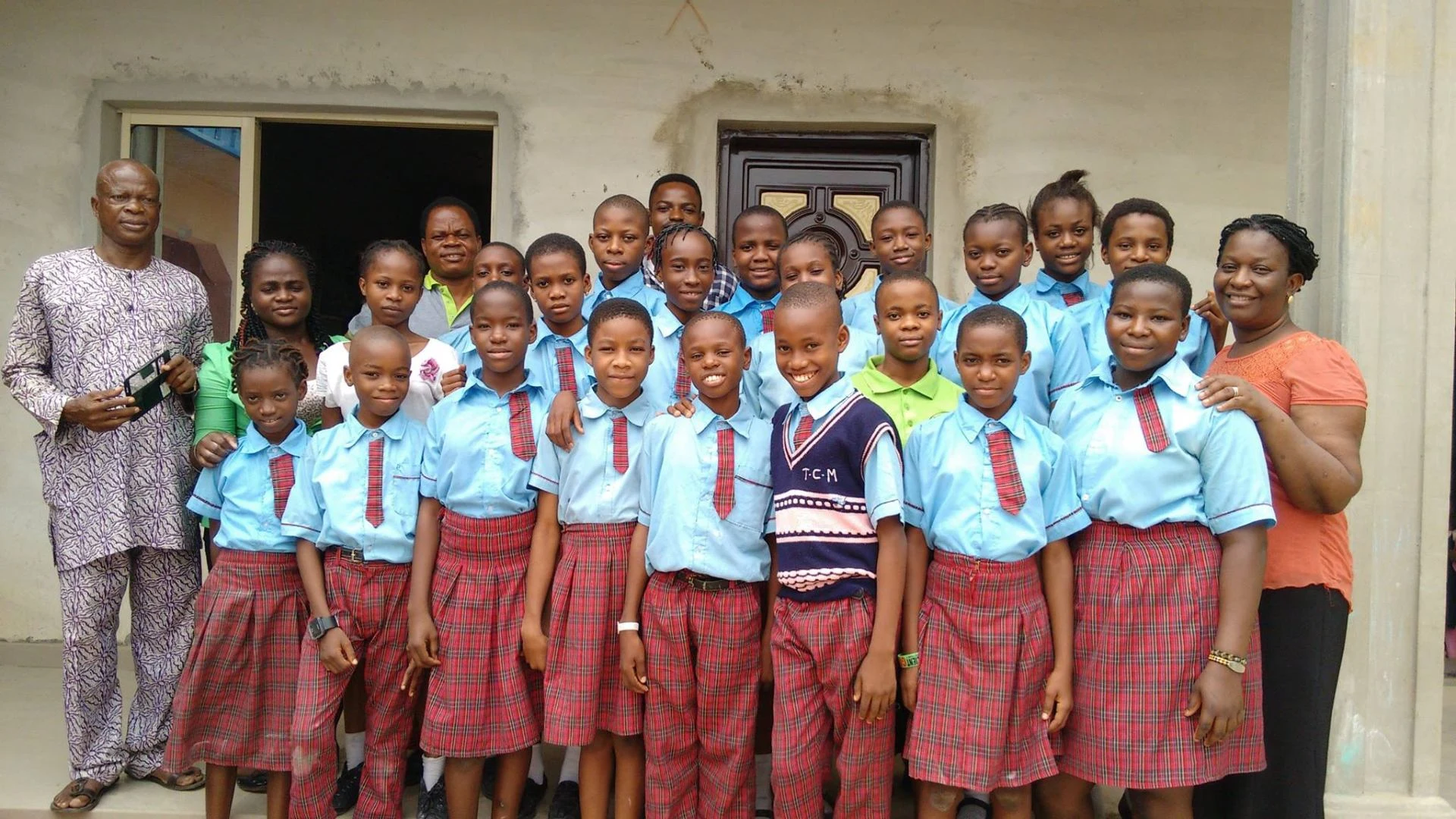 Students in blue uniforms at their school